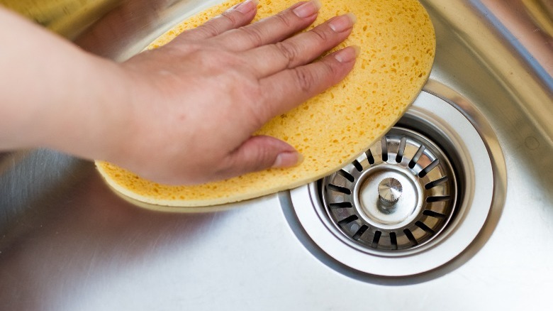 Yellow sponge in stainless steel sink