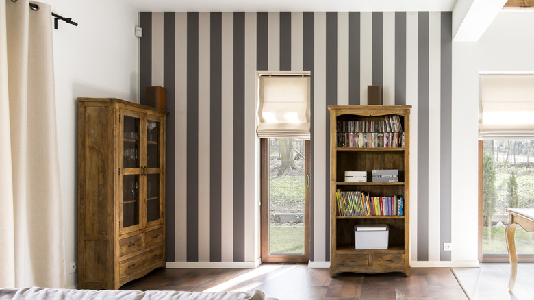 Doorway to a living room with black and white stripe accent wall