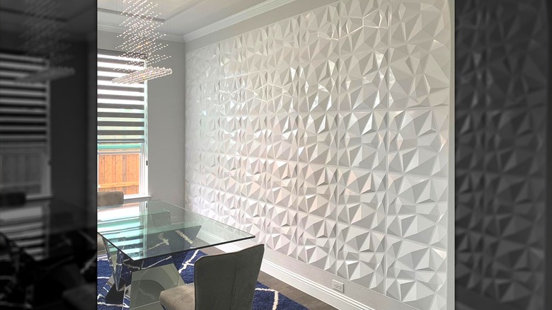 Dining room with a three-dimensional white accent wall