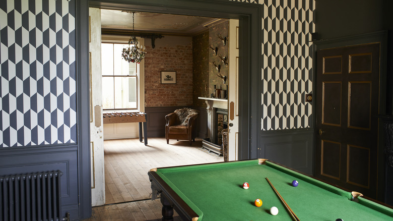 Game room in a home with black and white hexagon wallpaper