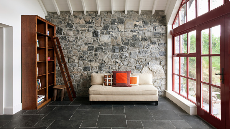 Living area with white sofa and stone accent wall