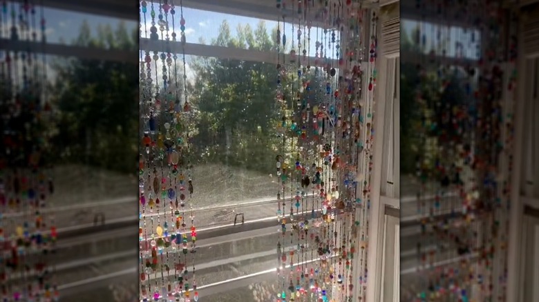 Colorful beaded curtains hanging on window