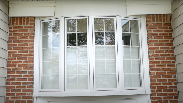 An outside view of bottom-up cellular blinds installed in a bay window