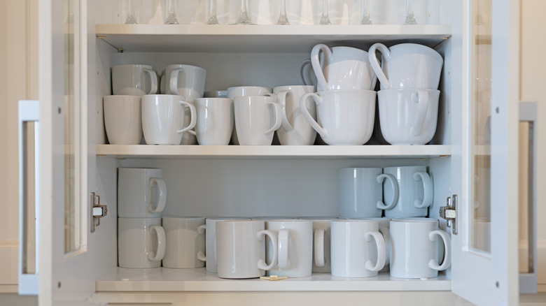 Mugs in kitchen cupboard