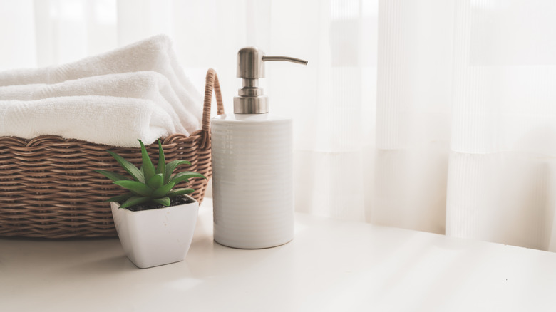 white lotion dispenser on counter