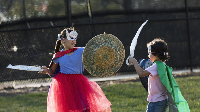 children swordfighting with shields