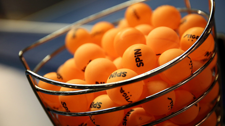 A basket of orange ping pong balls