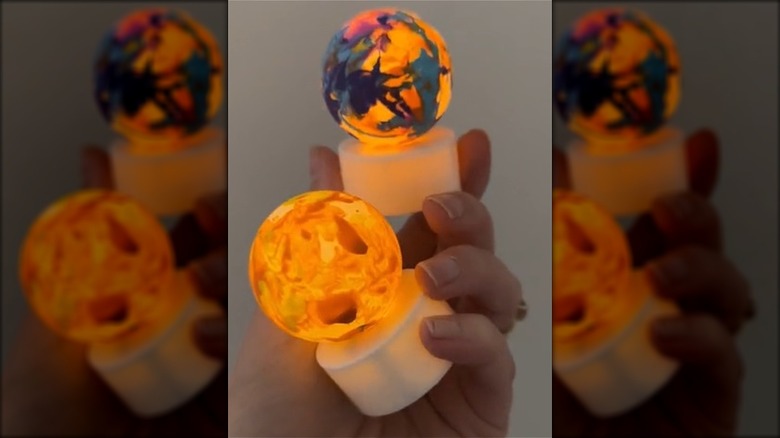 Painted ping pong balls on battery-operated tea lights