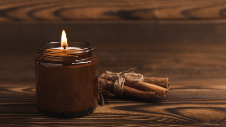 cinnamon candle on wood background