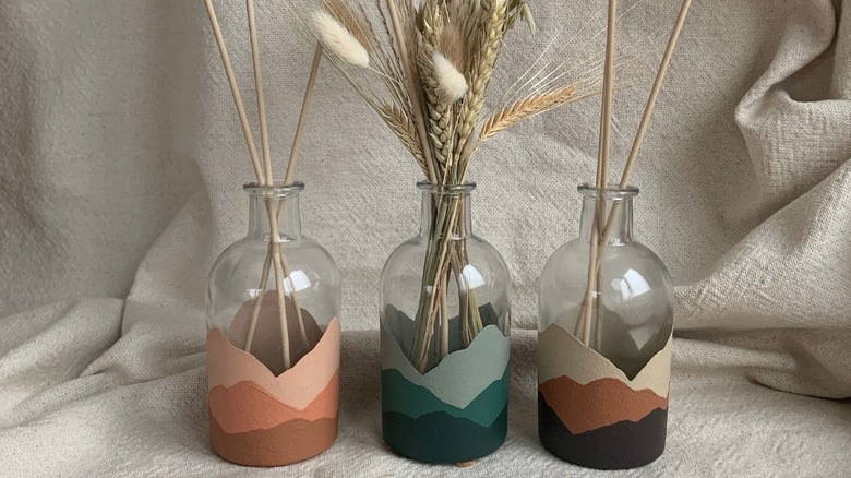 mountains painted on clear vases