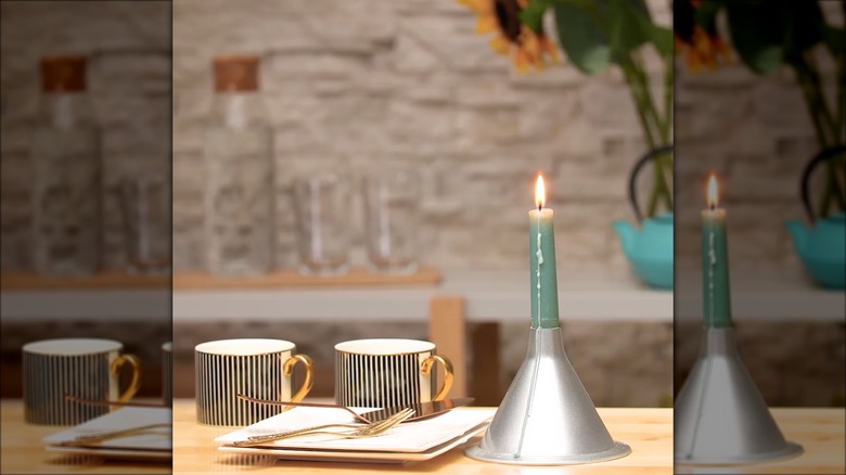 teal candle in funnel holder