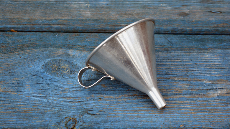 metal funnel on wood surface