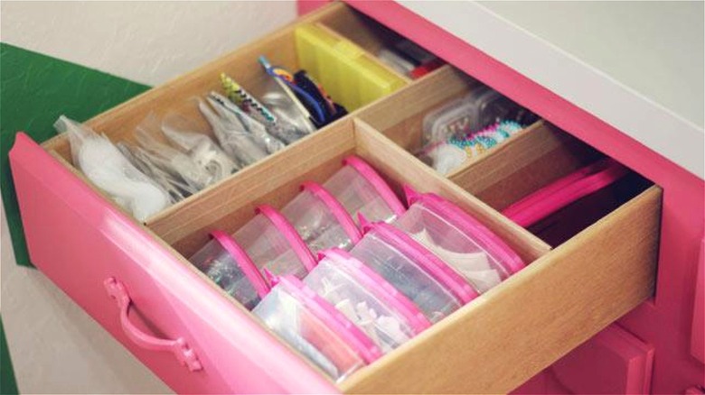 cardboard organizer in pink drawer