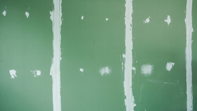 Green cement board affixed to the wall in a home