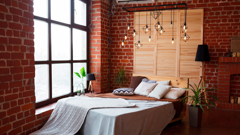 Exposed brick walls in an industrial-style bedroom