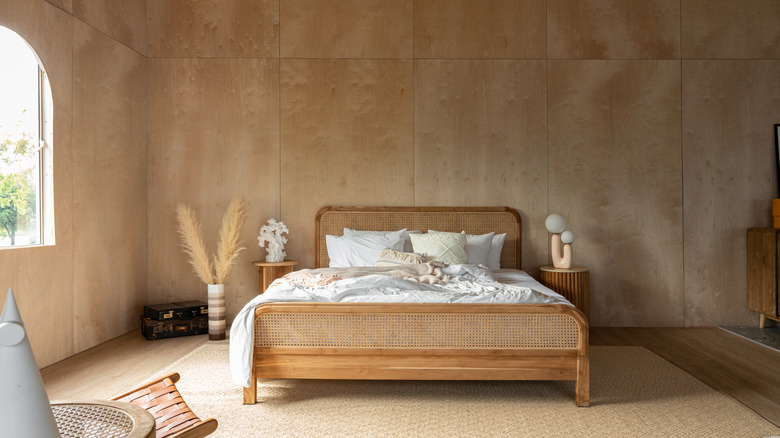 Plywood walls in a bedroom with rattan furniture