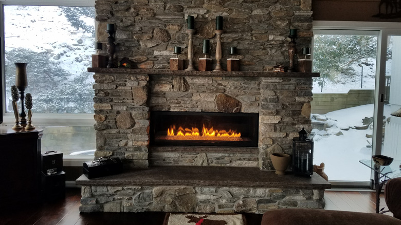 Stone veneer around a fireplace in a home