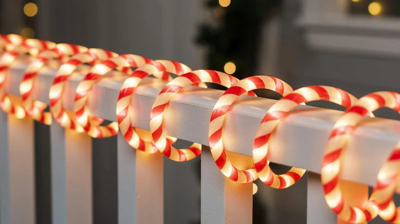 Candy cane light decorations along fence