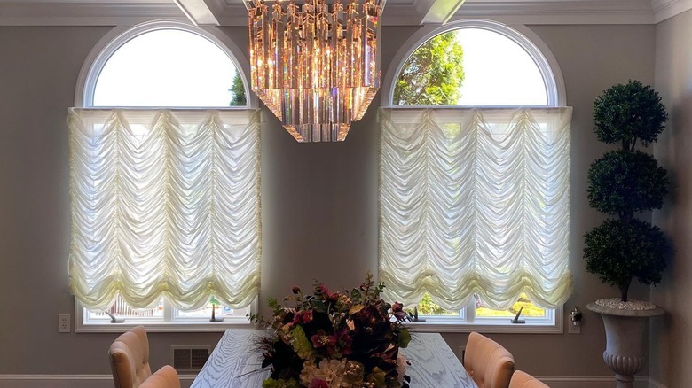 White Austrian window shades in a traditional dining room