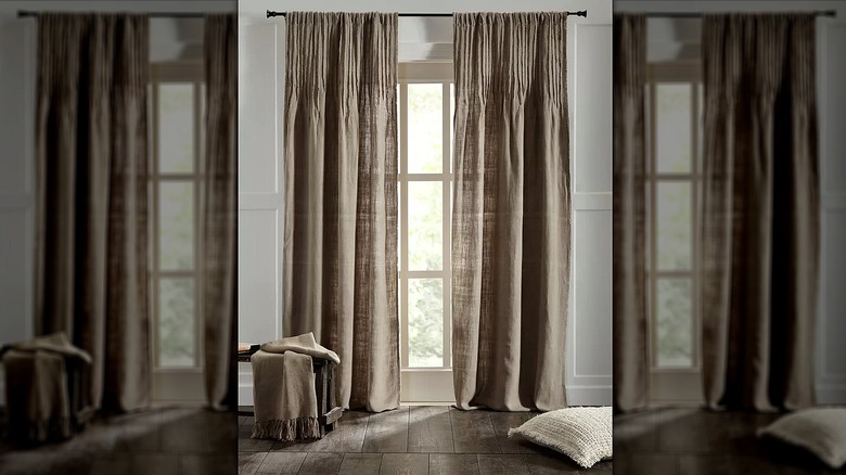 Linen curtains in taupe hanging above a window