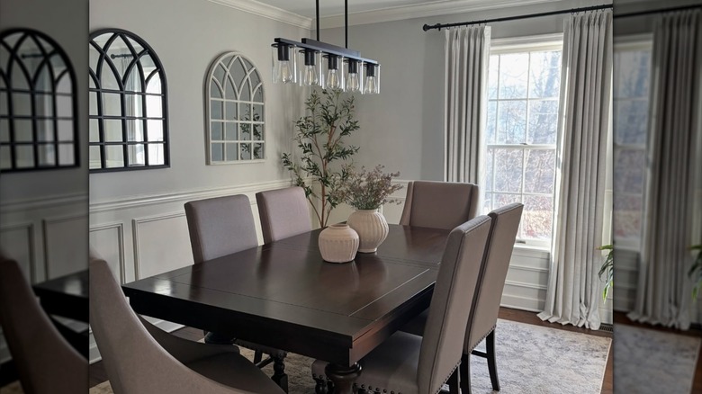 Dining room with floor-grazing gray curtains on windows