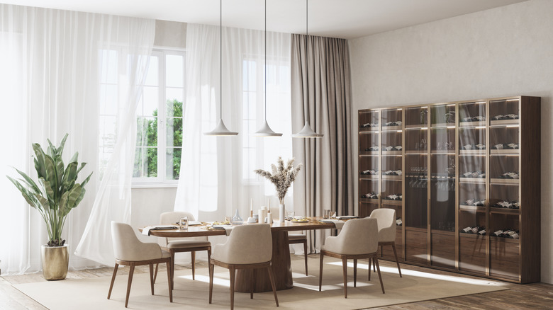 Floor-to-ceiling curtains in a modern dining room