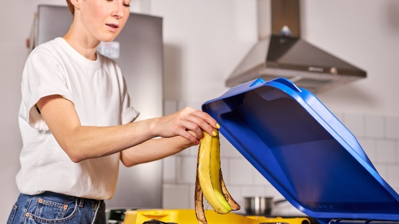 Woman disposing of banana peel 