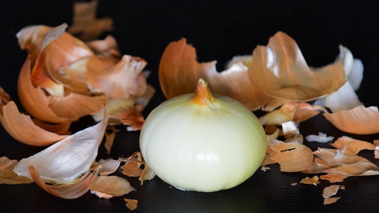 Peeled onion with skin and membrane