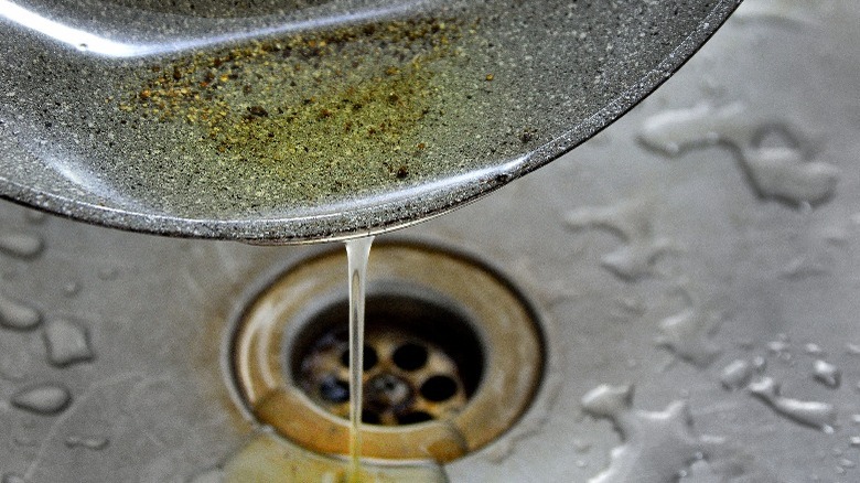 Pouring oil down garbage disposal