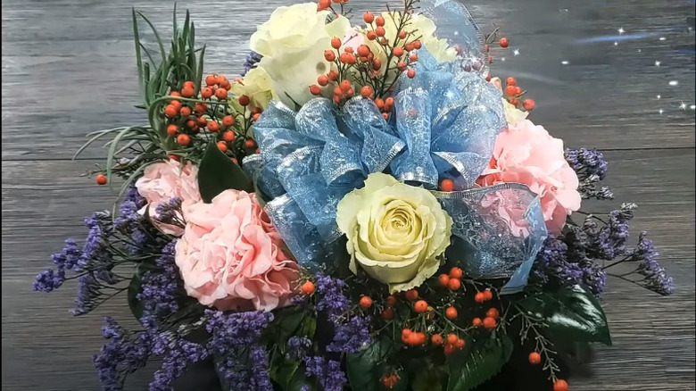 Floral centerpiece with cookie tin