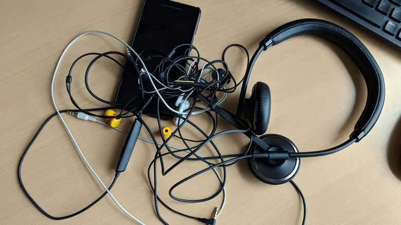 tangled electronics cords on desk