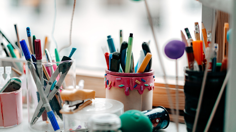 Cups holding pens and markers