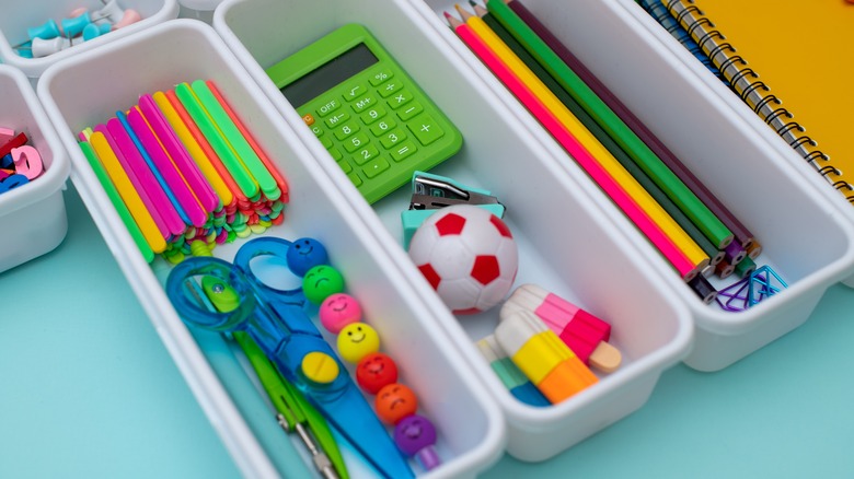 Containers holding office supplies