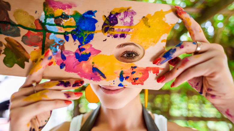 A woman holding a paint palette