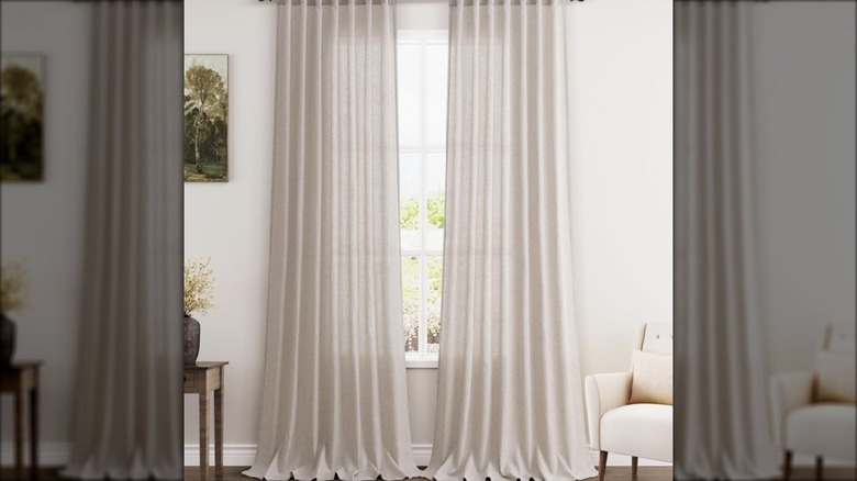 Long white curtains on window