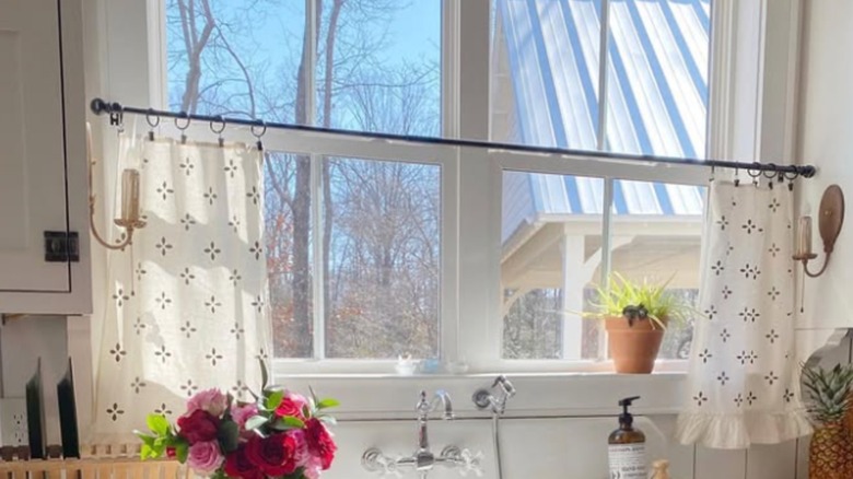 Patterned tea towels on window above sink