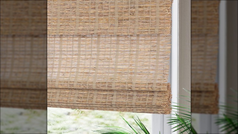 Woven bamboo shade in window