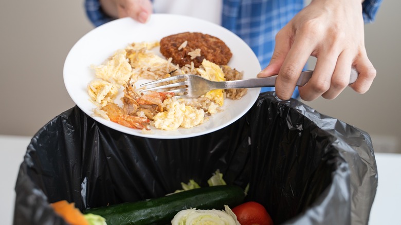 Dumping food in trash can