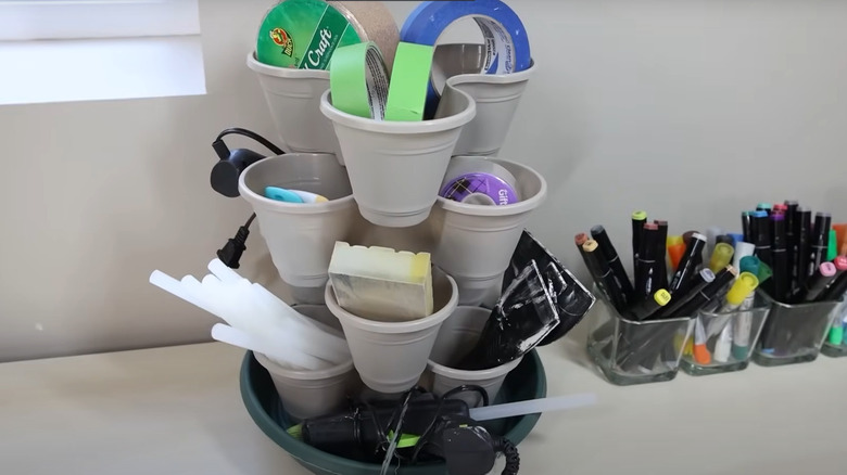 planter pots repurposed into tiered craft organizer on table