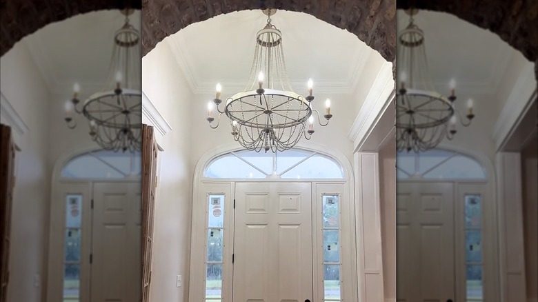 An empire chandelier hanging in a foyer