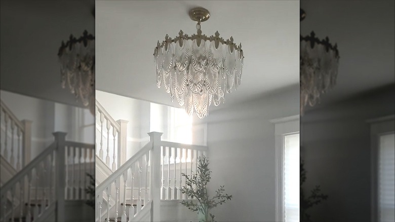 Glas leaf chandelier hanging in an entryway by stairs