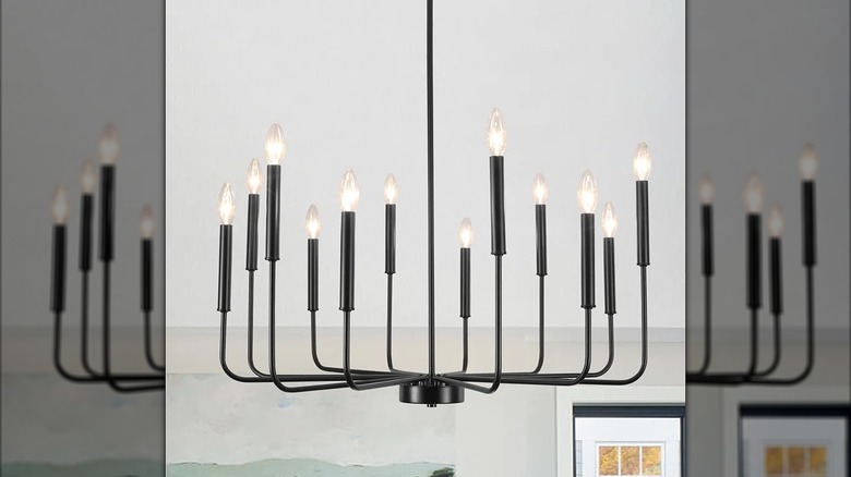 A black candelabra chandelier hanging from the ceiling