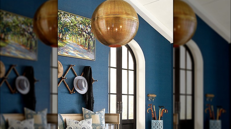 Large orb chandelier hanging in an entryway