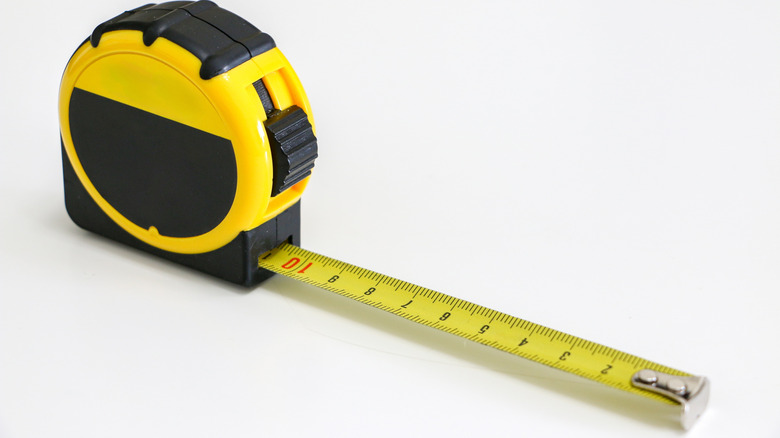 A black and yellow tape measure with a locking mechanism