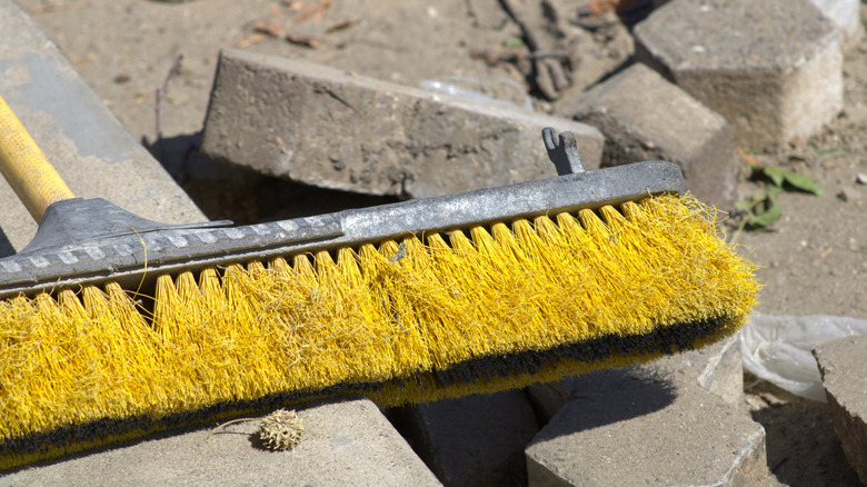 Broom with yellow bristles at a construction site