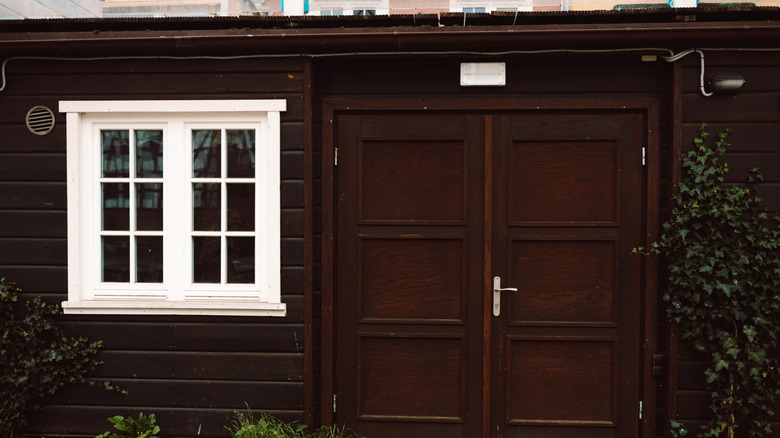 brown home exterior with windows and double doors