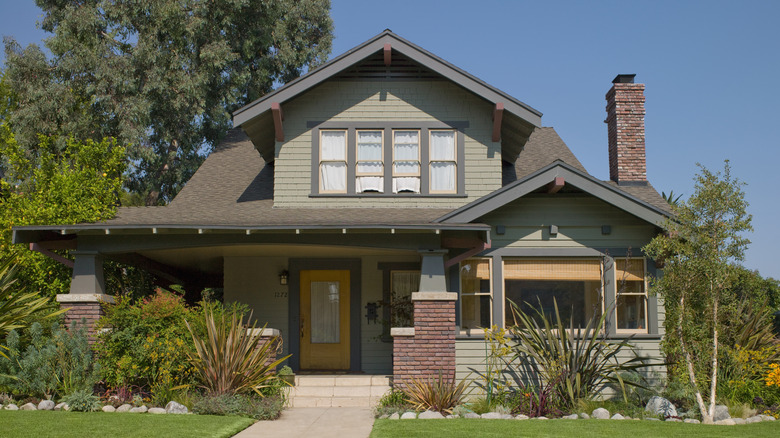 Green house with gray trim