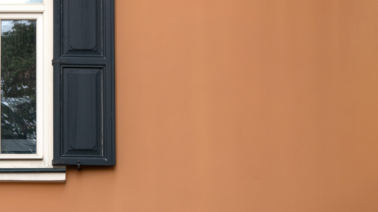 Orange wall with window and black shade