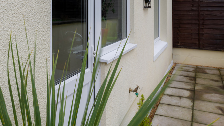 Cream stucco house with windows