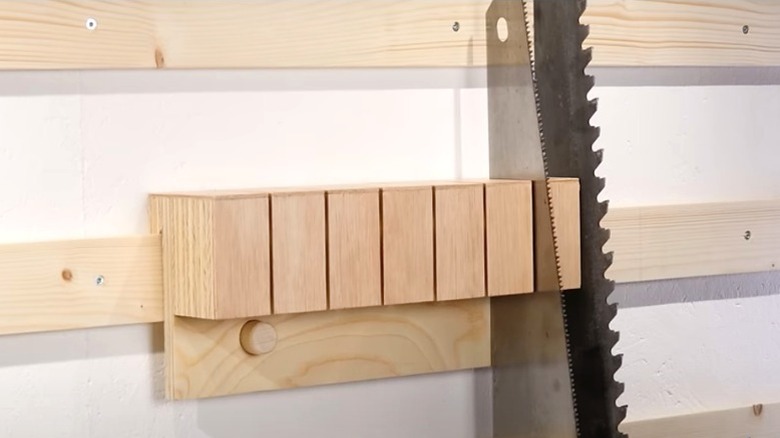 two hand saws held upright in DIY slotted French cleat holder